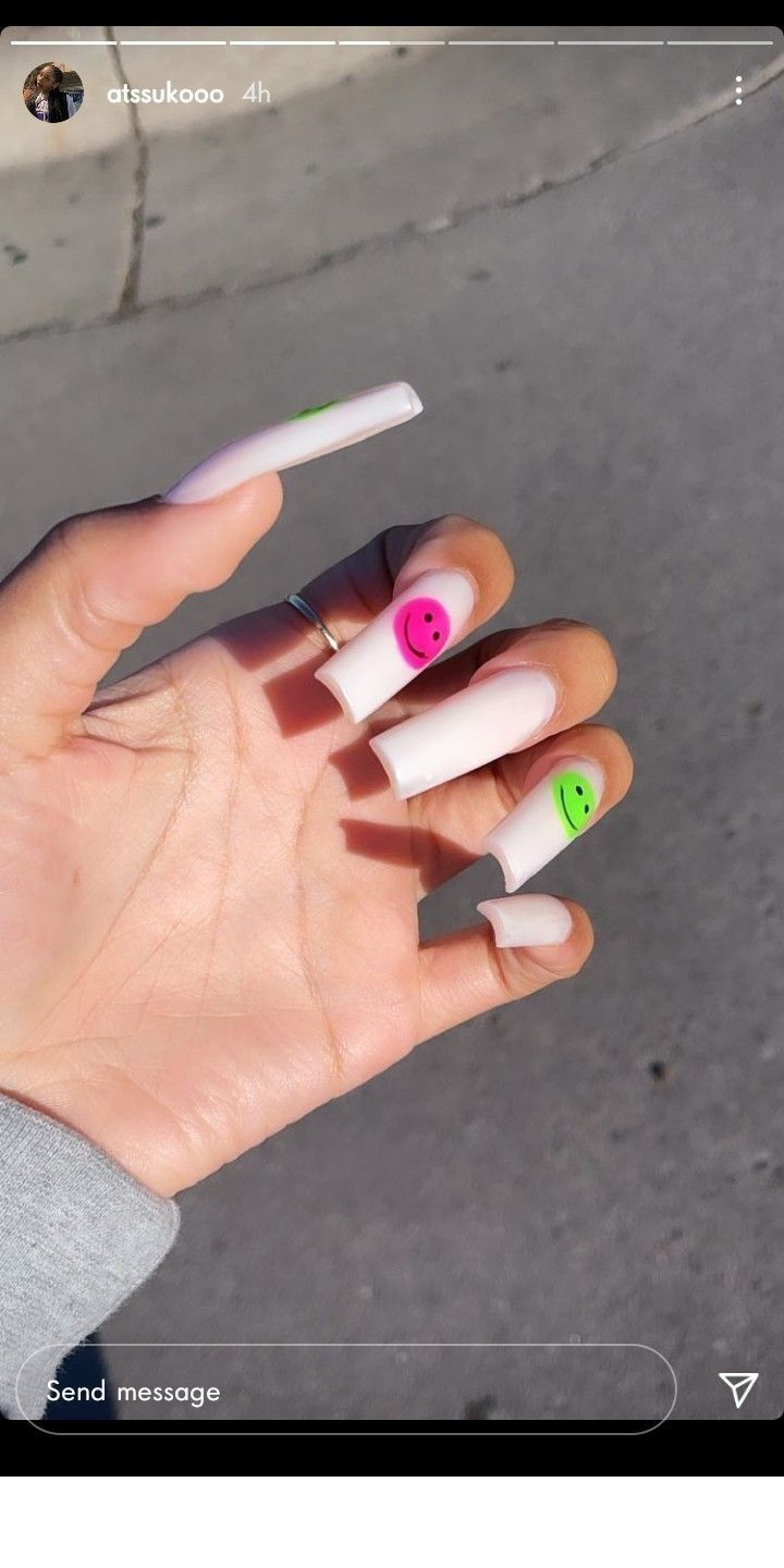 Whimsical Long White Nails with Playful Pink and Green Smiley Accents