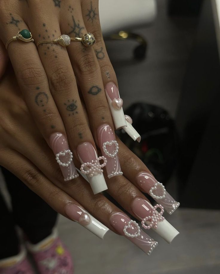 Chic Long Sculpted Nail Design with Intricate Details and Feminine Accents.