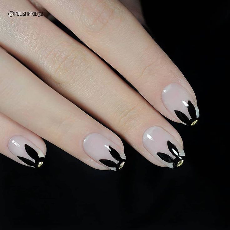 Elegant Nude Nail Design with Bold Black Accents and Glamorous Gold Tips