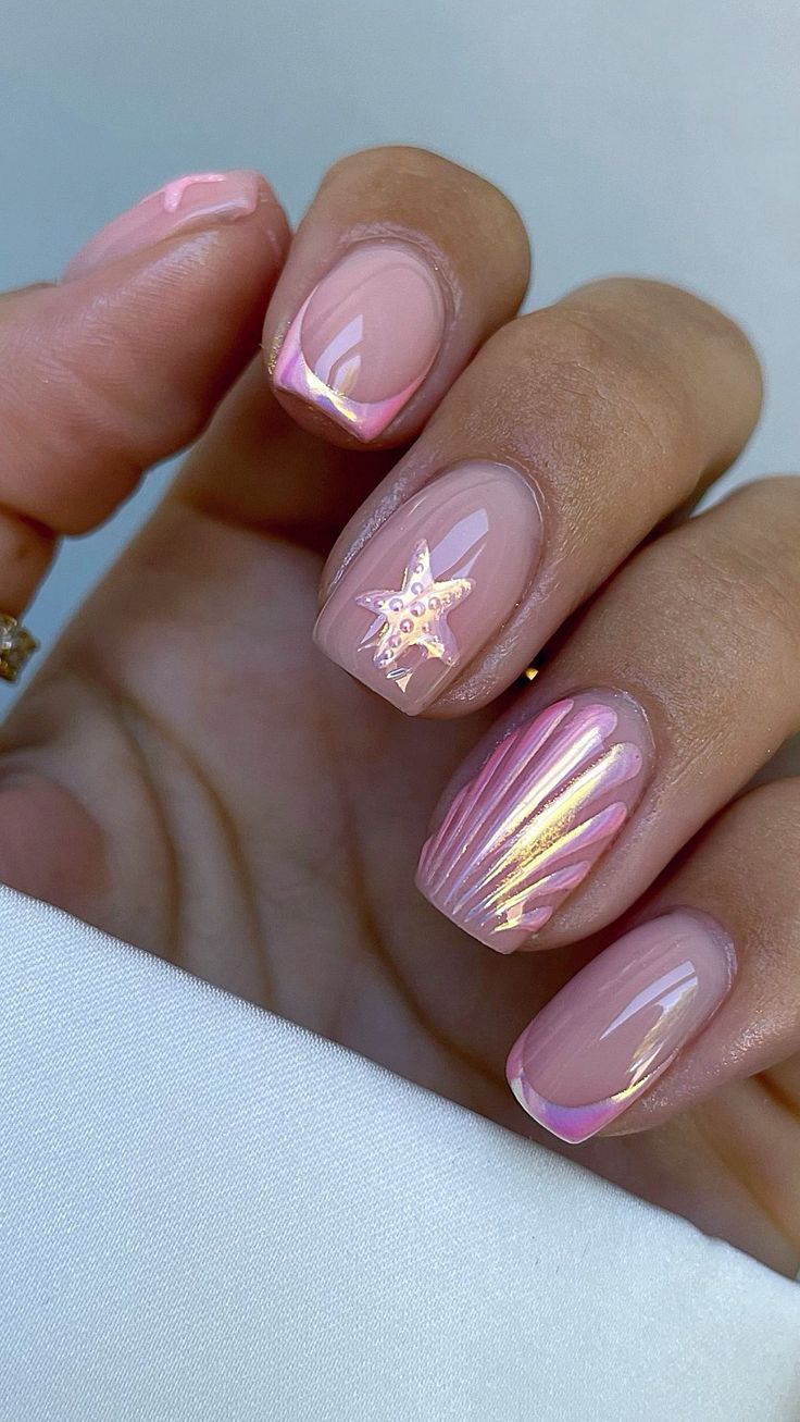 Sophisticated Soft Pink Nail Design with Delicate Gold Accents and Unique Embellishments.