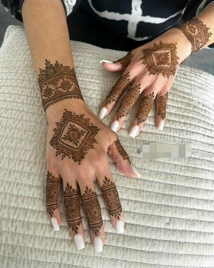 Elegant Intricate Henna Designs with Classic White Nail Polish Contrast