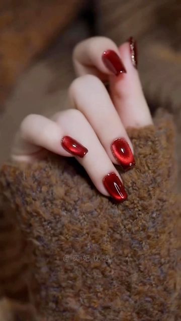 Sophisticated Glossy Red Nail Design with Chic Shape and Subtle Shade Variations.