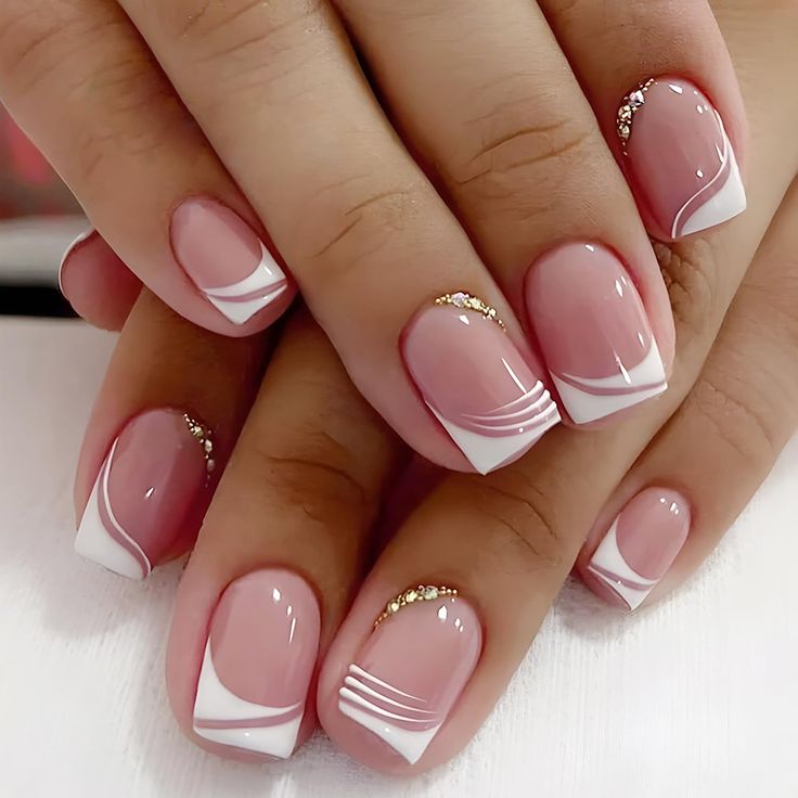 Elegant Pink and White Nail Design with Gold Accents: A Modern Twist on the French Manicure.