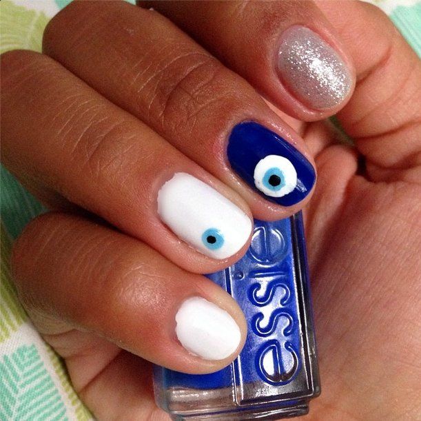 Artistic Eye Motif Nail Design: Vibrant White and Blue with Glitter