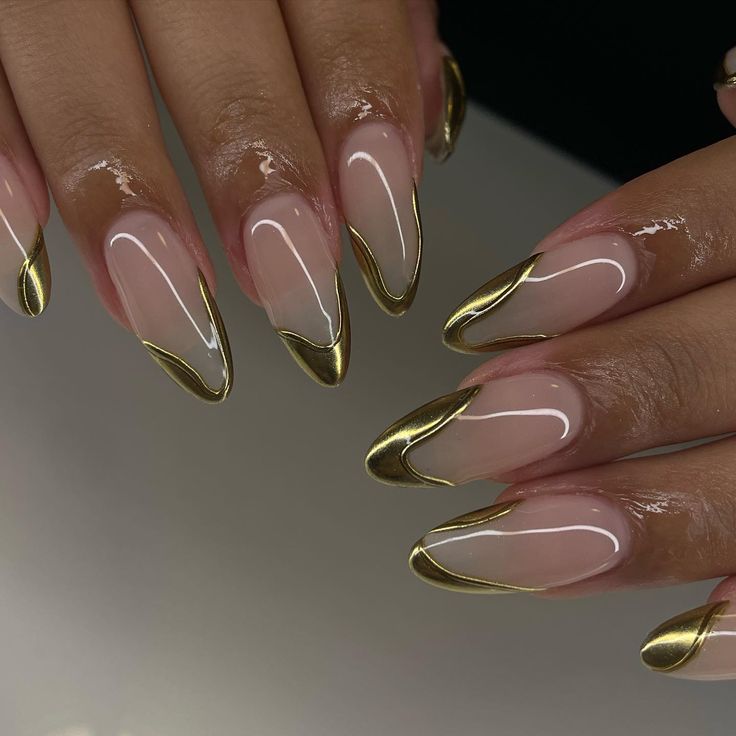 Chic Long Pointed Nails with Glossy Finish and Gold Tips for a Sophisticated Look.