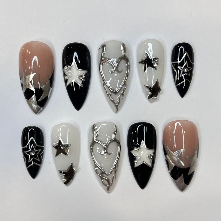 Trendy Nail Design with Black, White, Nude Tones and Metallic Silver Accents.