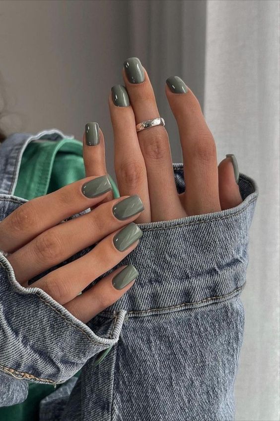 Sophisticated Glossy Green Nail Design with Earthy Elegance and Silver Accents.