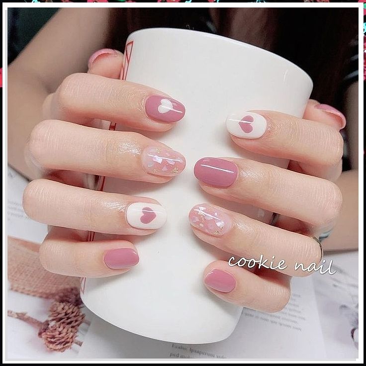 Romantic Whimsical Nail Design with Soft Pink, White, Hearts, and Floral Patterns