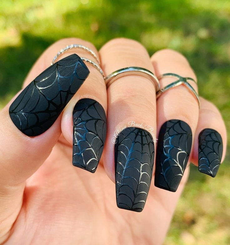 Chic Halloween Spiderweb Nail Design with Matte Black Base and Silver Accents.