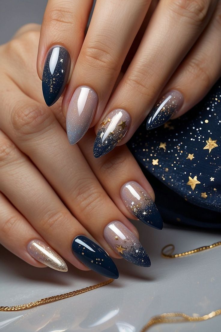 Celestial-Inspired Nail Art: Elegant Deep Navy and Gold Ombre Design with Sparkling Stars.