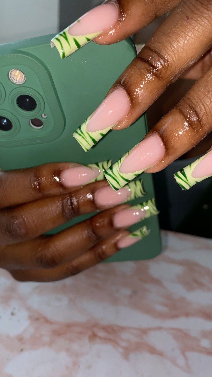 Bold Trendy Nail Design with Soft Pink and Vibrant Green Accents Featuring Leafy Patterns.