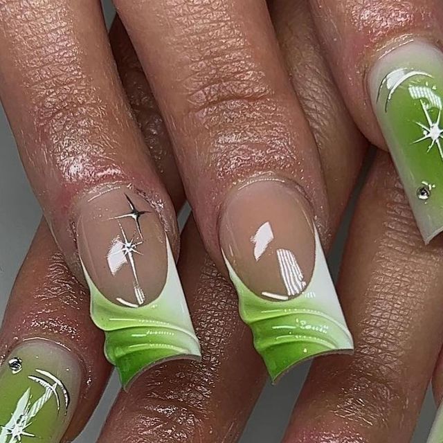 Sophisticated Green Ombre Nail Design with Intricate Details and Sparkling Accents.