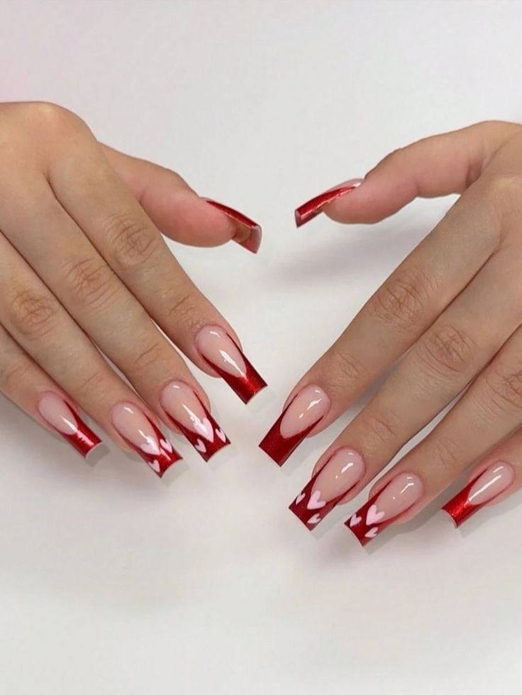 Chic Nude and Red Nail Design with Heart Patterns for a Flirty Look.