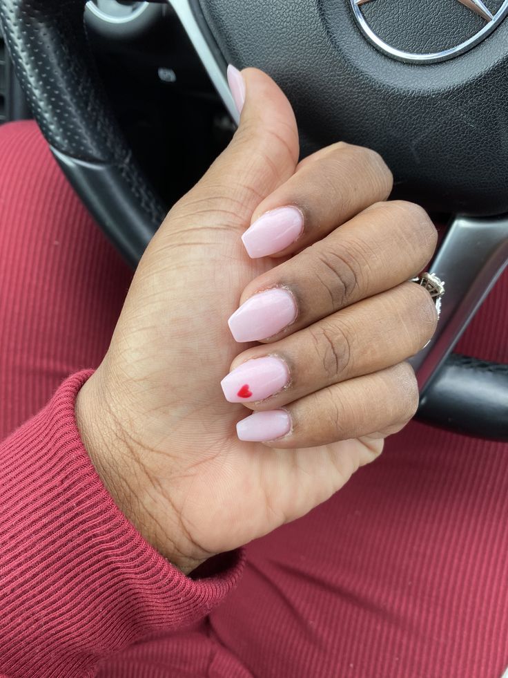 Chic Soft Pink Nail Design with Charming Red Heart Accent