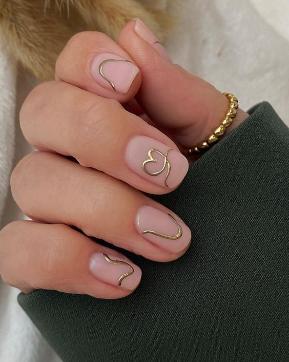 Chic Nude Nail Design with Whimsical Gold Wire Accents