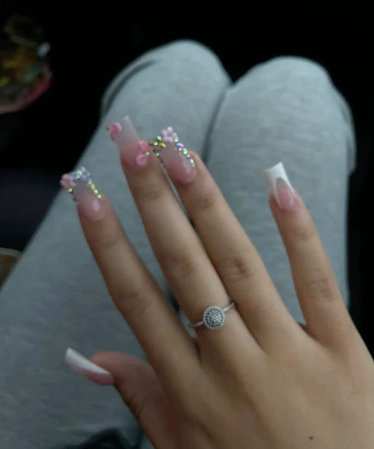 Chic Long Ombre Nails with Floral Embellishments and Sparkling Accents.