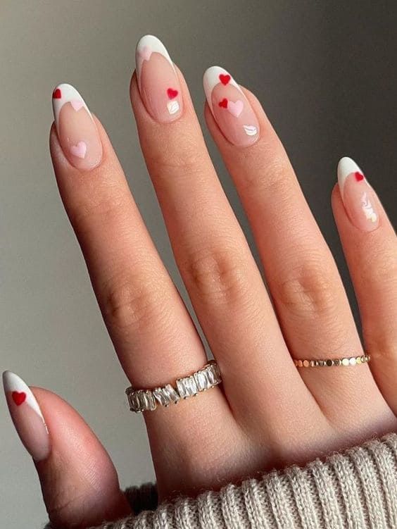 Playful French Manicure with Romantic Heart Accents for a Whimsical Touch.