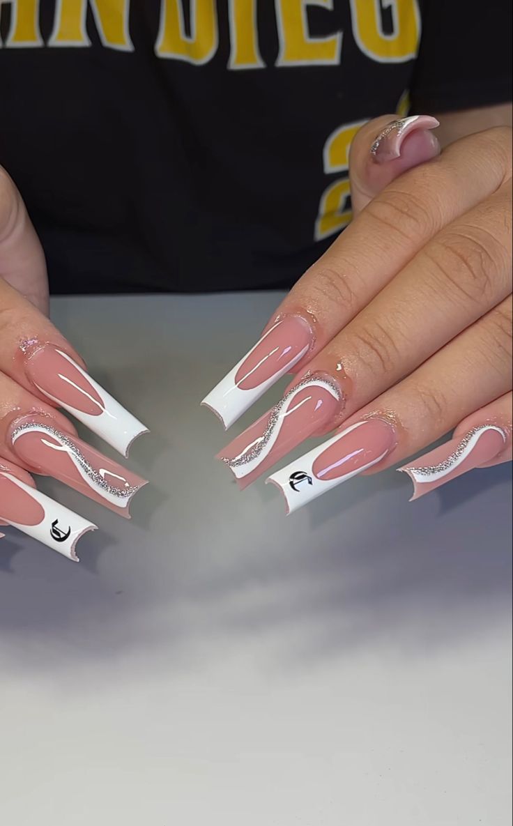 Sophisticated Blush and White Nail Design with Elegant Silver Accents.