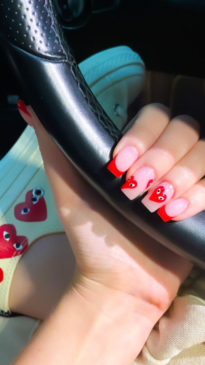 Vibrant Heart-Themed Nail Design: A Playful Blend of Red Tips and Delicate Accents.