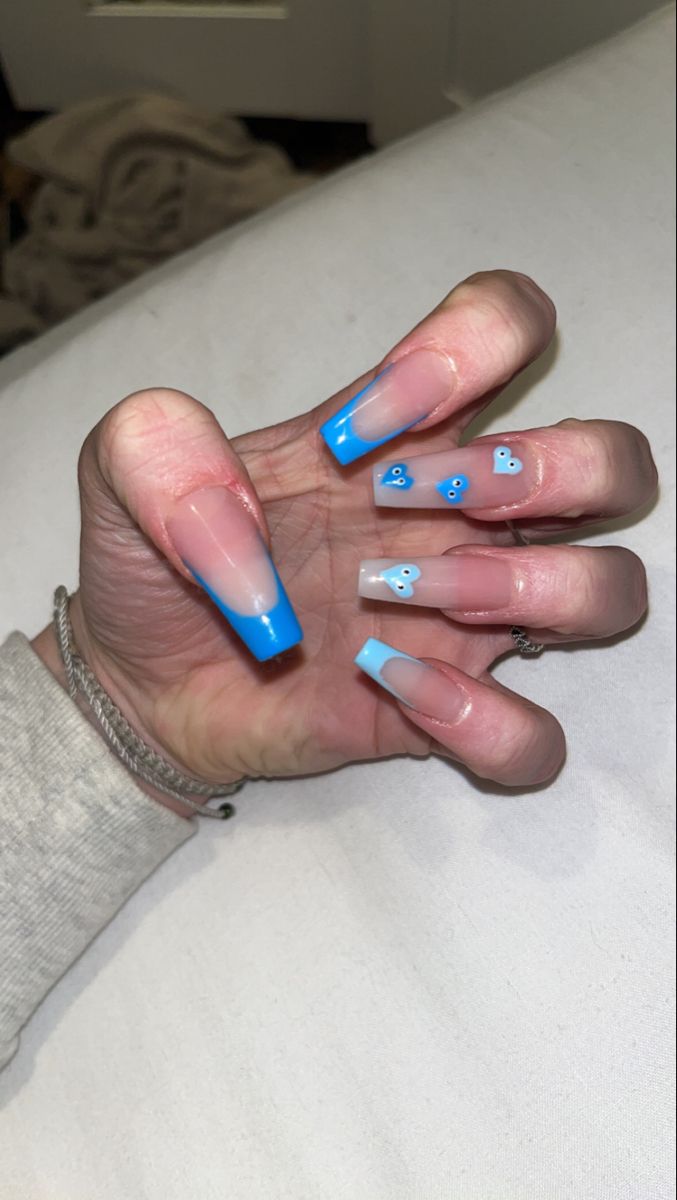 Modern French Manicure: Vibrant Blue-Tipped Elegance with Playful Pastel Accents.