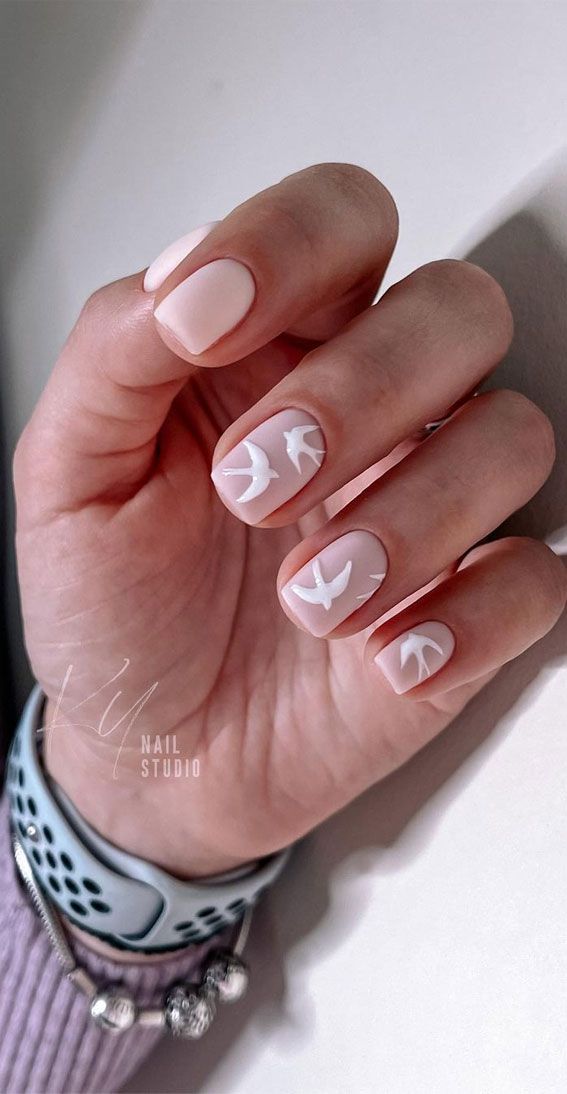 Elegant Minimalist Nail Design with Soft Nude Base and Whimsical White Bird Motifs