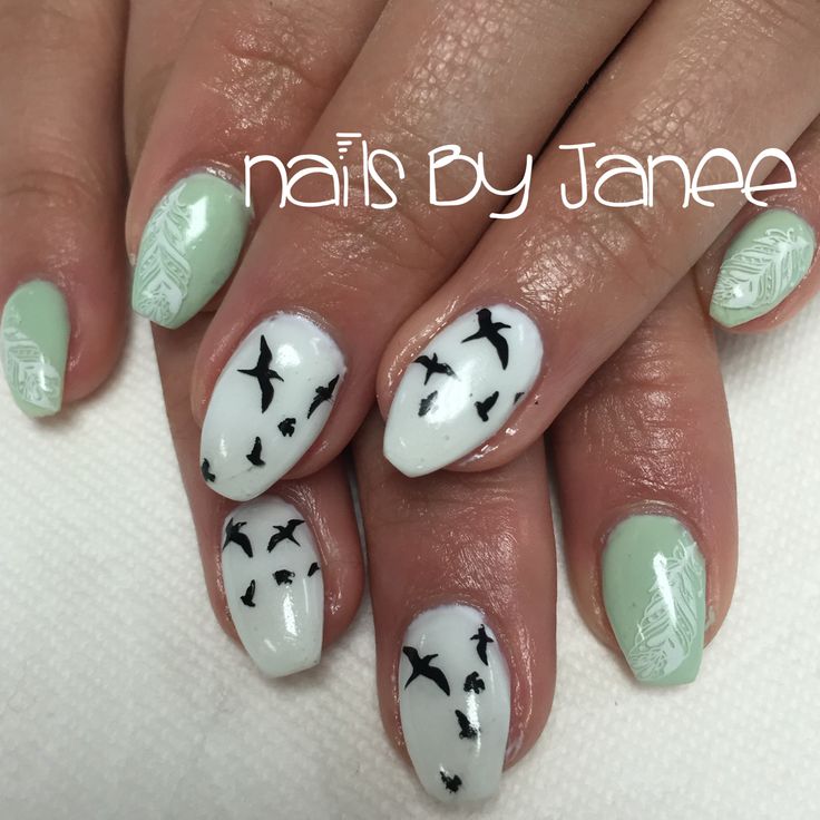 Whimsical Mint Green and White Nail Design with Black Bird Silhouettes and Floral Accents.