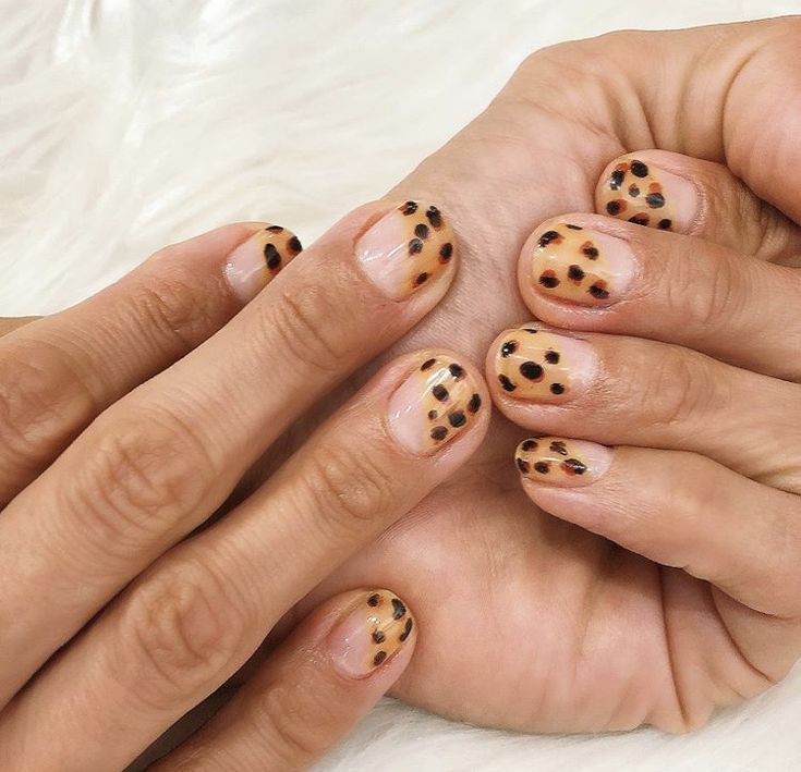 Chic Leopard Print Nail Design: Subtle Nude Base with Black Spots for Trendy Versatility