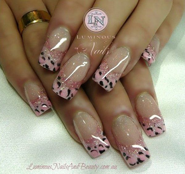 Chic Gradient Nail Design with Soft Pink Hues and Playful Black Spots.