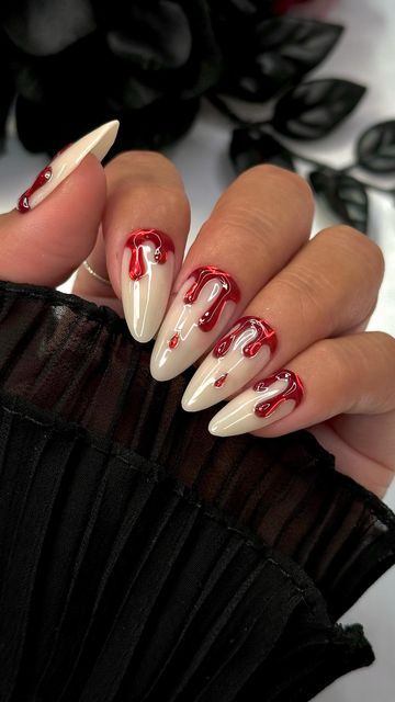 Chic Nail Design: Bold Beige and Red Contrast with Whimsical Dripping Patterns.