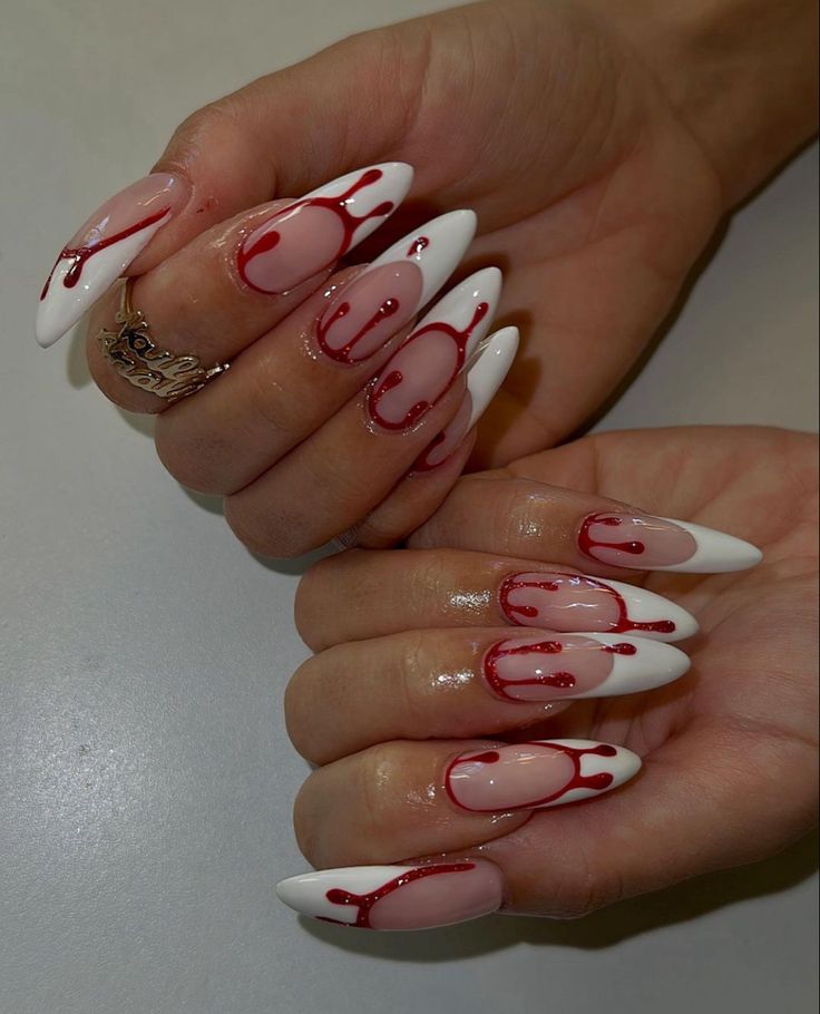 Bold Stiletto Nail Design with Glossy White, Soft Pink, and Vibrant Red Drips.