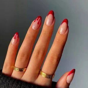 Edgy Red and Nude Nail Design with Bold Drip Accents.