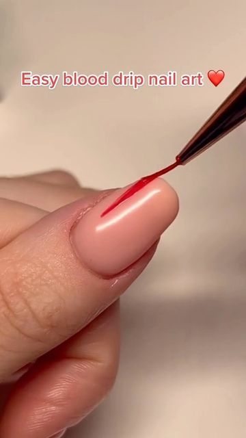 Bold Blood Drip Nail Art Design with Glossy Nude Base and Vivid Red Accents.