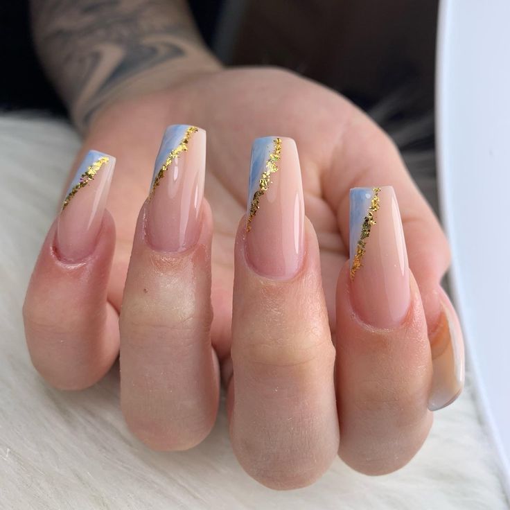 Chic Acrylic Nails with Nude and Soft Blue, Enhanced by Elegant Gold Stripes.