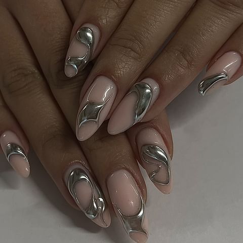 Modern Elegance: Soft Pink Nail Design with Sculptural Silver Accents