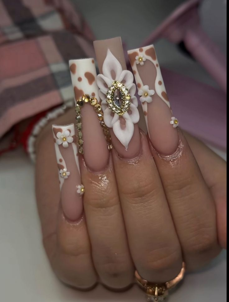 Elegant Floral Nail Design with Long Tips and Glamorous Rhinestones.