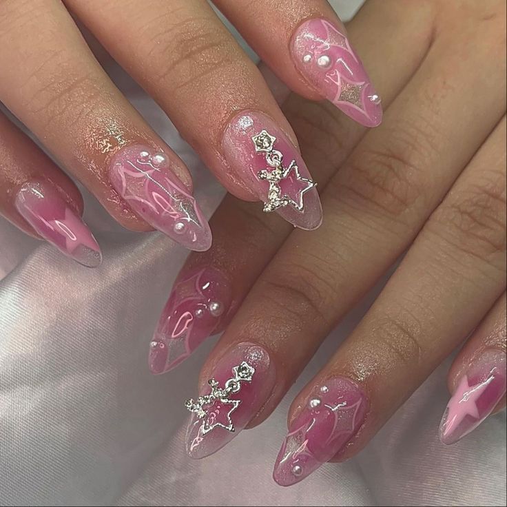 Sophisticated Elegant Pink Stiletto Nail Design with Swirls, Pearls, and Silver Accents.