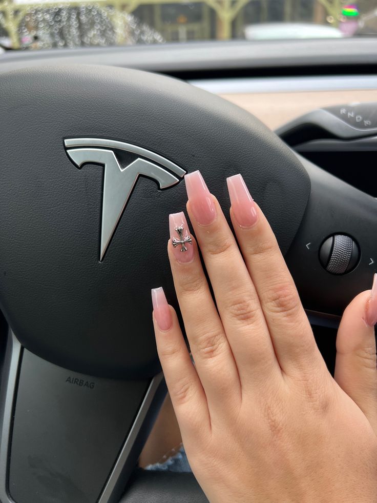 Chic Pink Acrylic Nails with Decorative Charm Enhance Luxury Style in Modern Car Interior