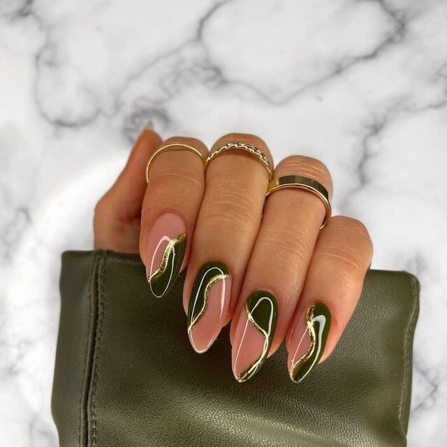 Chic Almond-Shaped Nail Design: Soft Pink and Deep Green with Wavy Accents and Gold Rings.