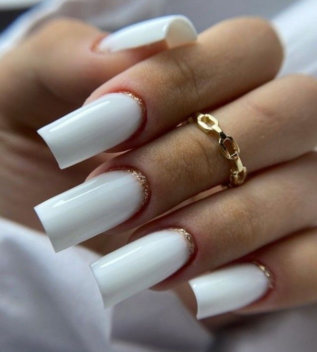 Sophisticated White Nails with Glossy Finish and Golden Accents for Any Occasion.