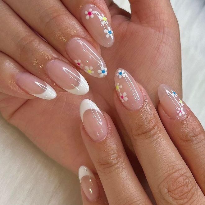 Elegant Floral Nail Design: Pastel Flowers on a Nude Base with Classic French Tips.