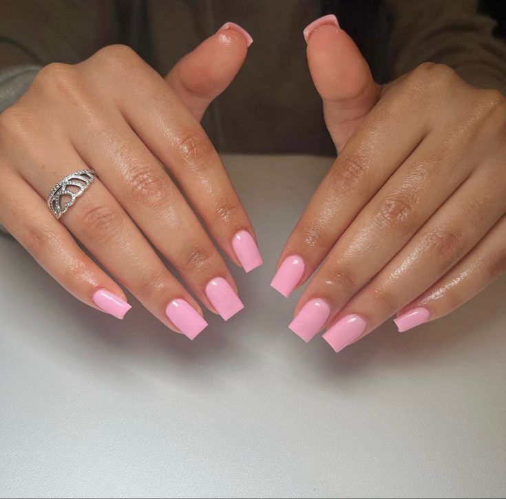 Chic Elegant Pink Manicure with Glossy Finish and Sophisticated Silver Ring Detail