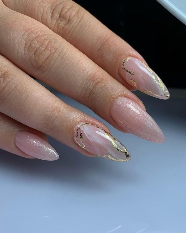 Sophisticated Soft Pink Nail Design with Shimmering Gold Foil Accents.