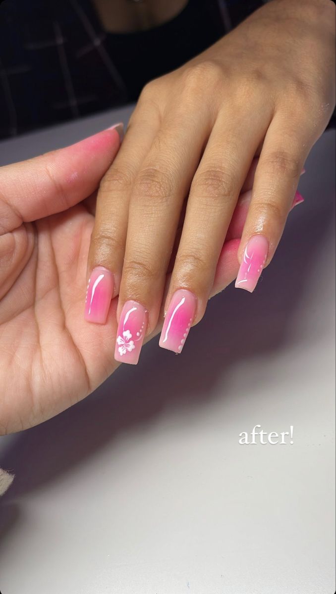 Chic Ombre Pink Acrylic Nails with Floral Designs and Gem Accents.