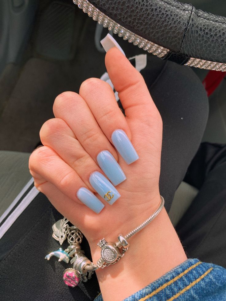 Elegant Light Blue Nails with Glossy Finish and Playful Gold Accent