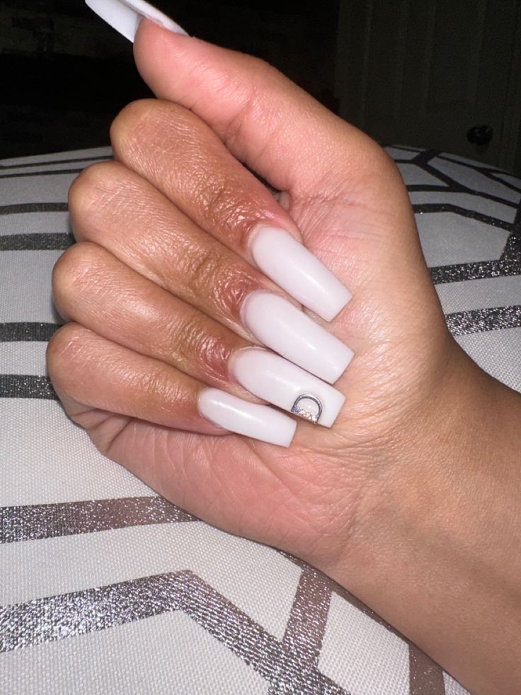 Chic Modern Elegance: Glossy White Long Nails with Unique Accent Design.