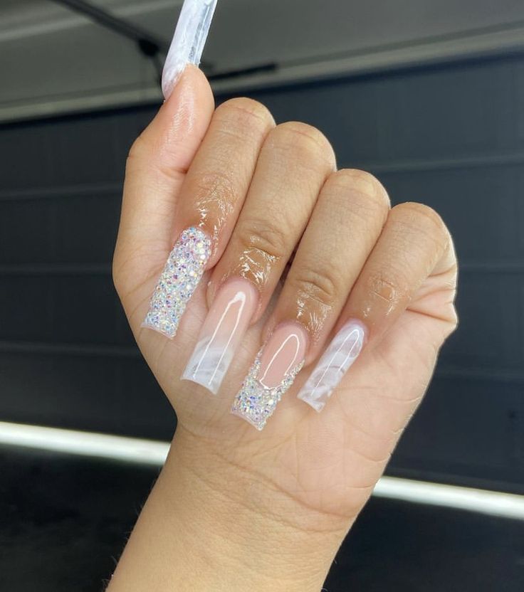 Chic Nail Design: Combining Clear & Glitter with Unique Shapes and Textures.