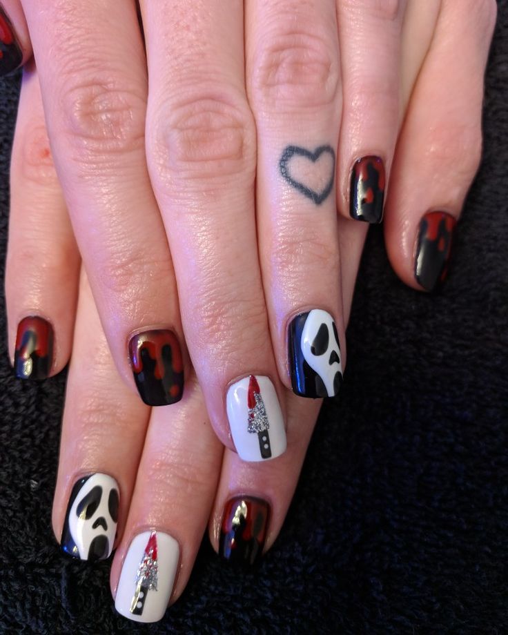 Spooky Halloween Nail Design with Ghost Faces and Blood Drips