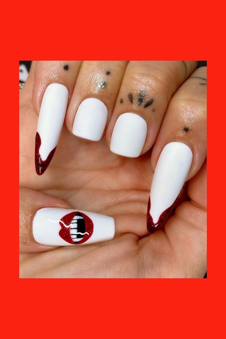 Vampire-Inspired Nail Design: Bold Red and Glossy White with Drippy Tips and Playful Accent.