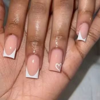 Elegant Nude and White Nail Design with Heart Accents and Distinctive Shapes.