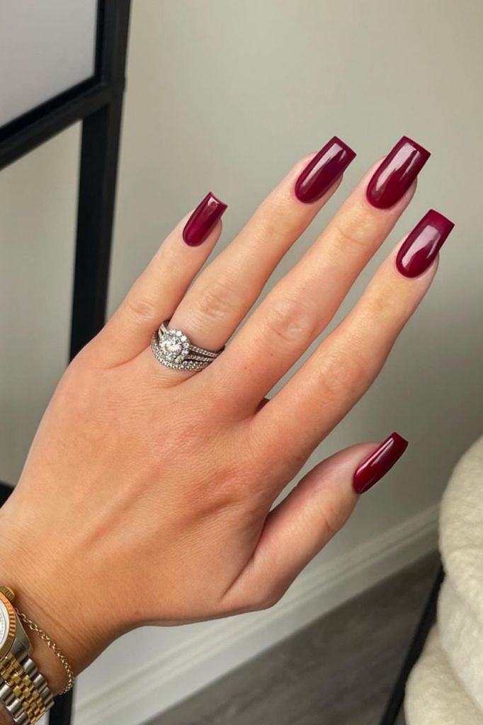 Chic Burgundy Nails: Strikingly Elegant with Glossy Finish and Long Square Shape.